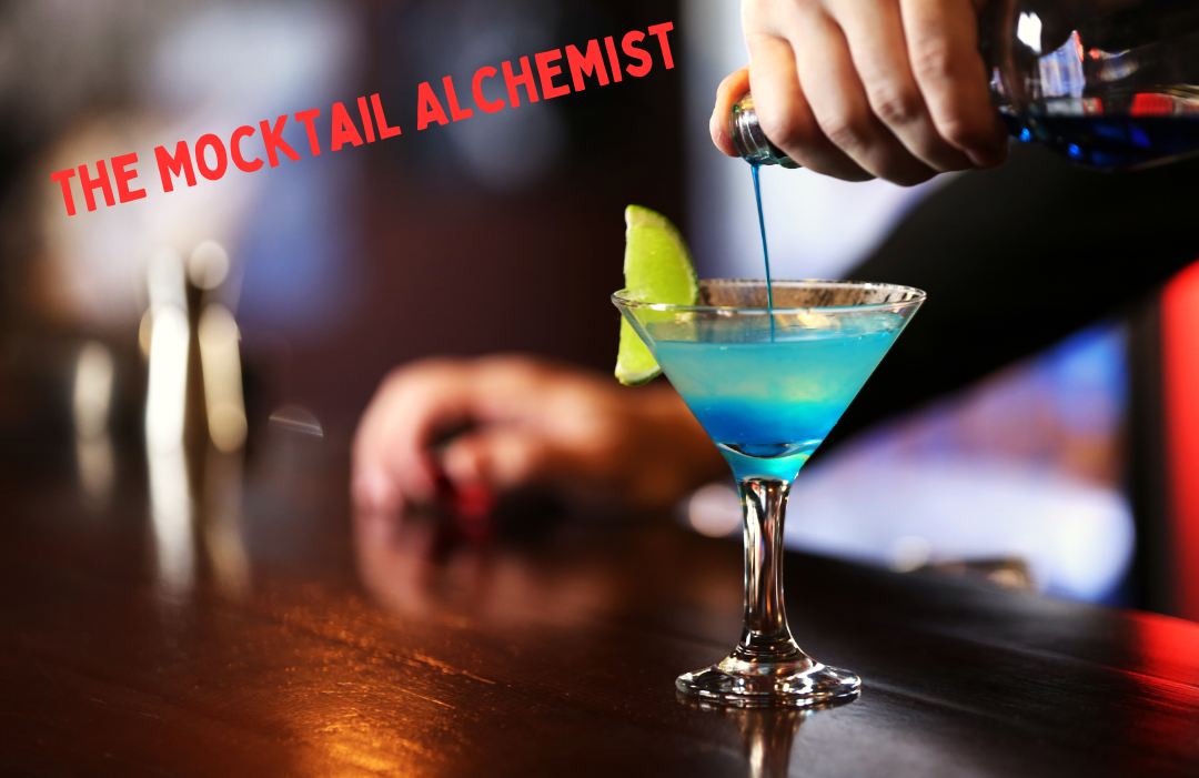 A bartender prepares a mocktail that has a lemon wedge on the glass rim.